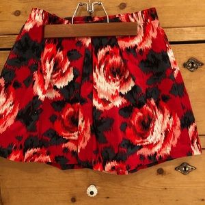 Red skirt with black and white roses on it